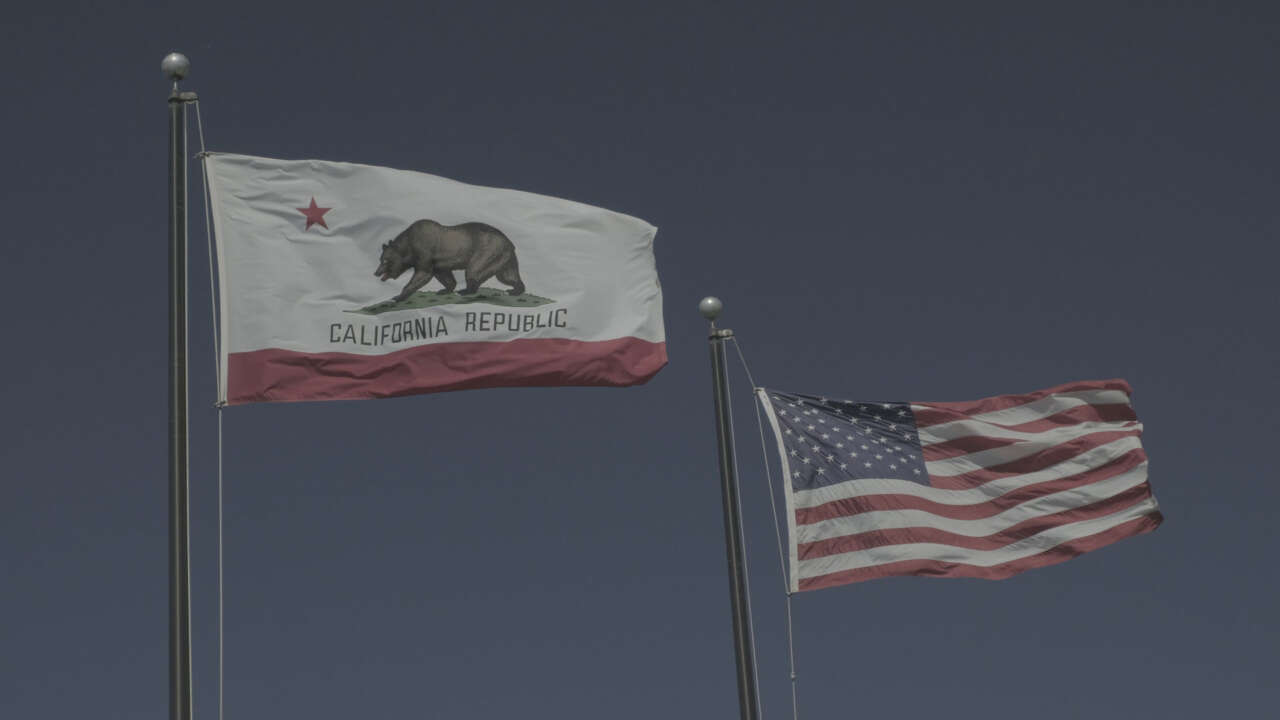 usa and california flag waving in heavy wind